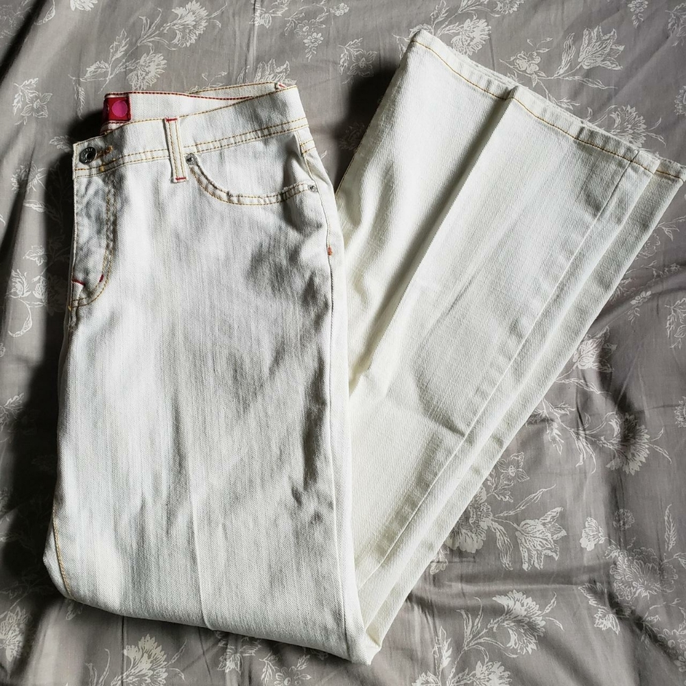 y2k style white mid-rise flare jeans with red and gold stitching